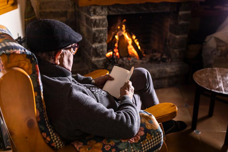 Older person in front of fire