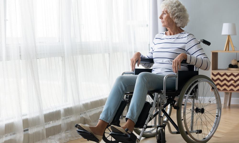Older lady in wheelchair at wondow