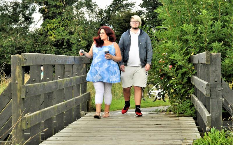 Man and woman on wooden bridge
