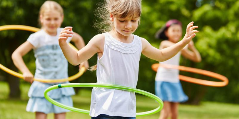 Young girls playing hula hoops