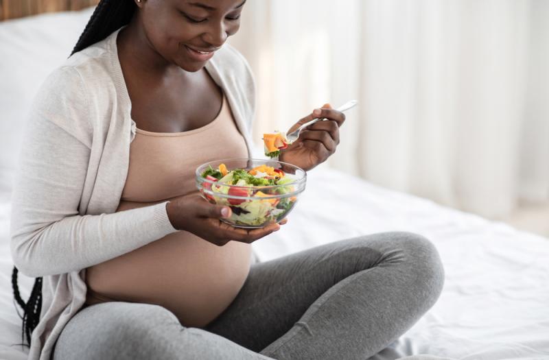 Pregnant lady eating salad