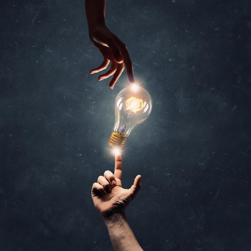 Two hands and a light bulb